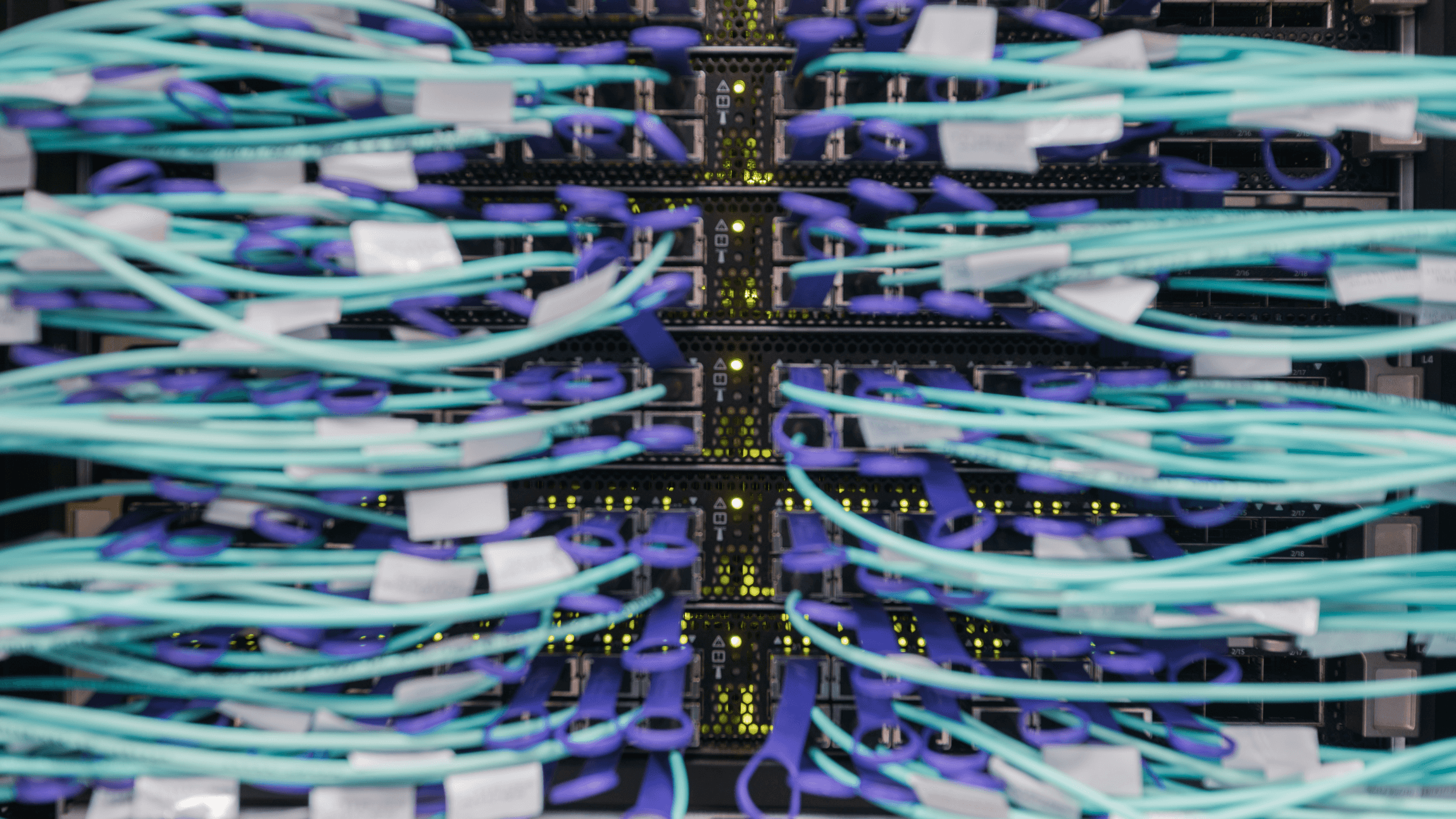 Cable cords plugged into a middle of row switch configuration.